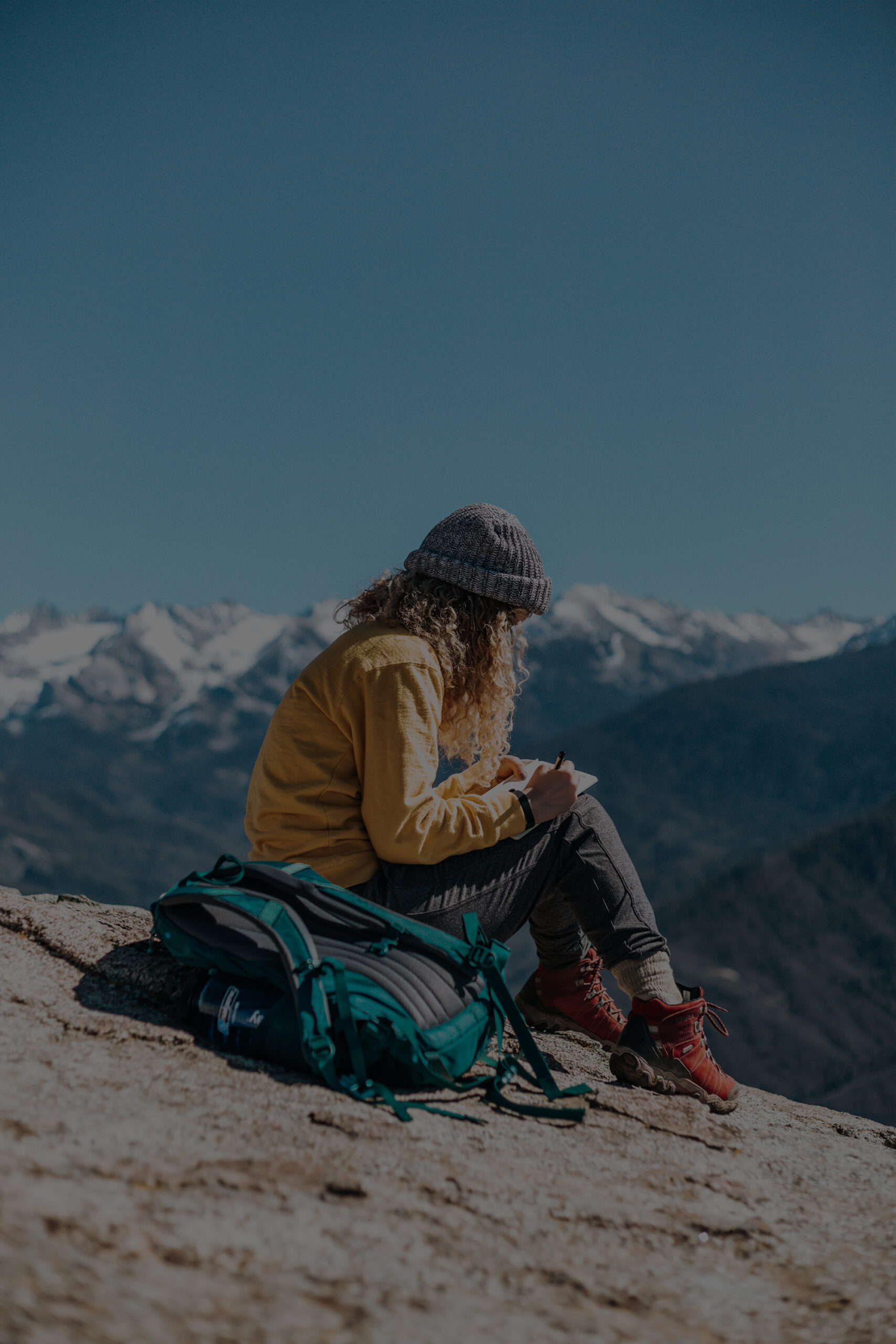 Women sitting on rock in wilderness
