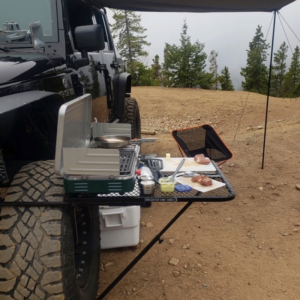 Tailgater Tire Table Large Aluminum Camping Table with stove preparing a meal